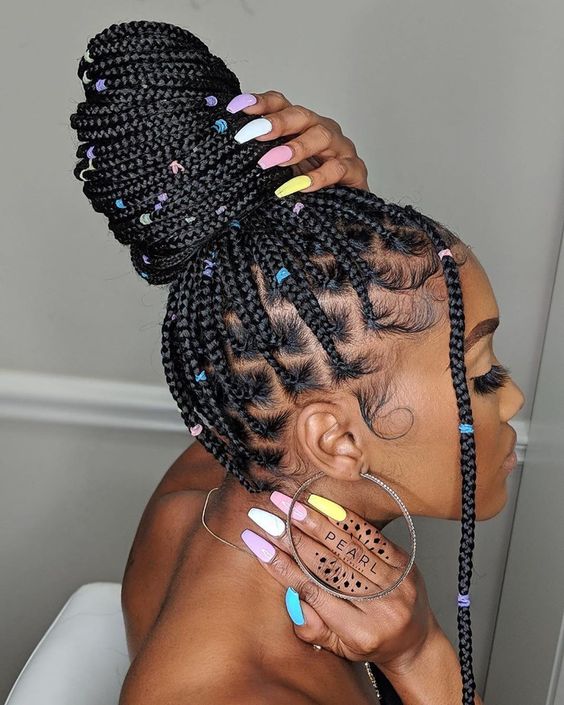 rubber band box braids with colorful beads in a bun