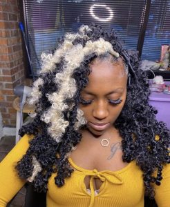 fluffy butterfly locs with blonde streaks