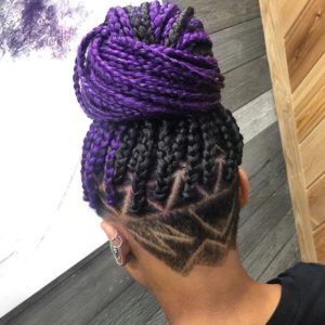 half purple box braids with shaved design