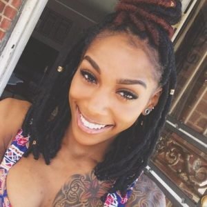 half up half down faux locs with a touch of red
