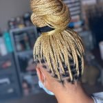 blond knotless braids in a bun using rubber band method