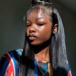 half up half down sew in with textured bun and wispy bangs