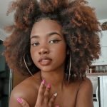 half up half down with pigtail buns on long natural hair