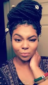 high bun with cowrie shells goddess locs