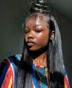 half up half down sew in with textured bun and wispy bangs